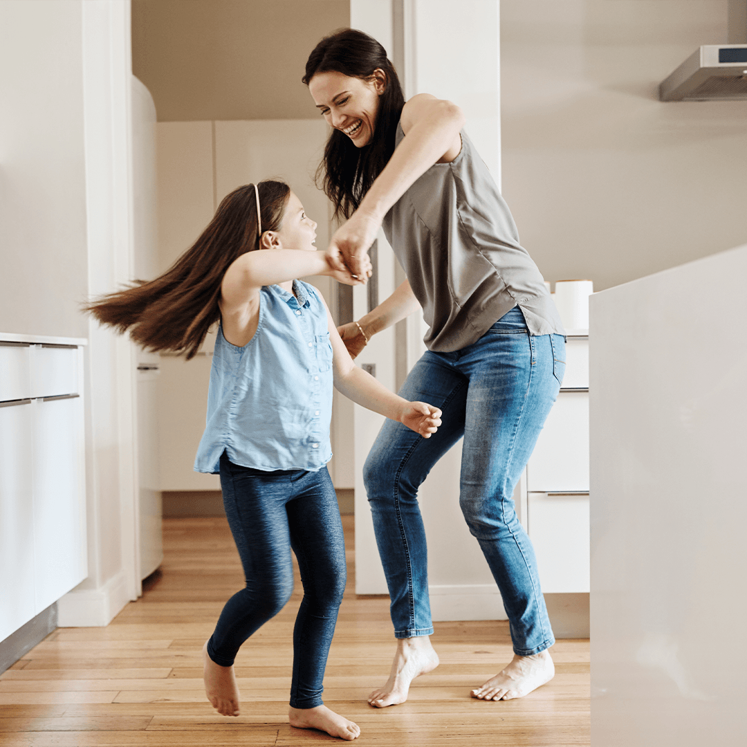 Mom and daughter dancing in the kitchen – joyful everyday movement for kids